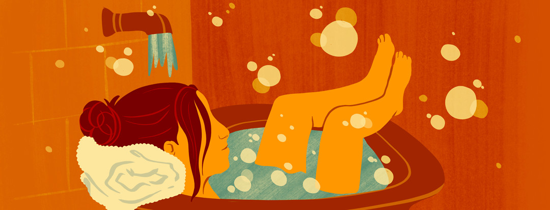 A woman with axial spondyloarthritis takes a relaxing bubble bath