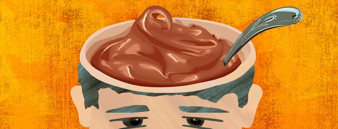 A man's head is open at the top, forming a bowl shape for chocolate pudding with a spoon handle emerging from the pudding.