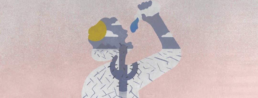 A silhouette of a person drinking water from a bottle. In the silhouette is a desert scene