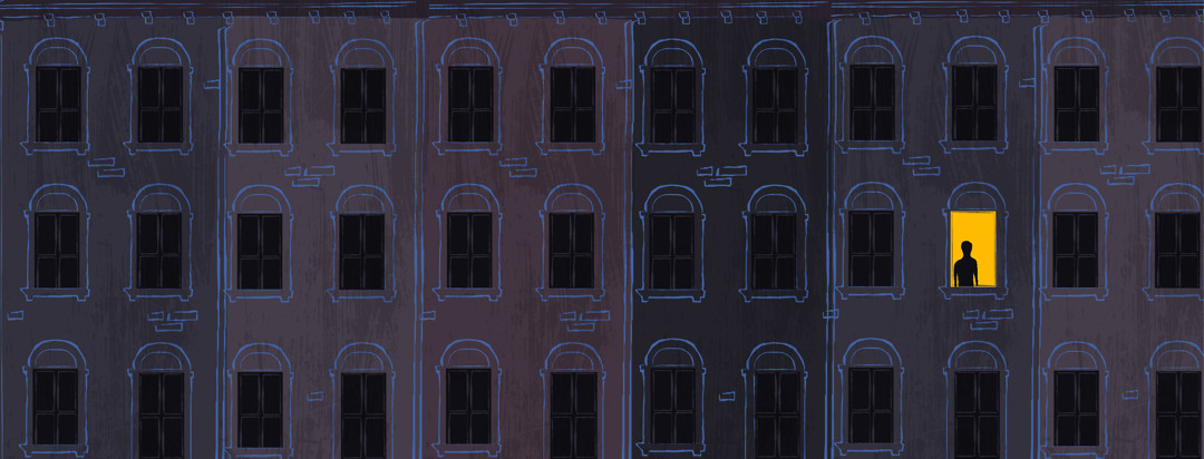 Silhouette of a person in the one lit window in a row of dark houses at night.