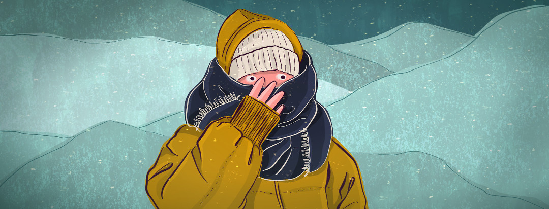 A person bundled up in winter weather clothing outside, clutches their scarf closely to their face.