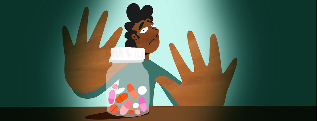 A man puts his hands up to a bottle of NSAIDs, looking wary.