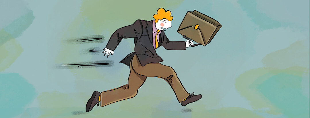 A business man dressed in business attire and running with his briefcase.