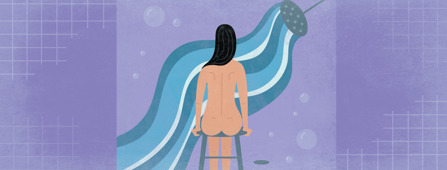 a woman relaxes while sitting on a stool in her shower