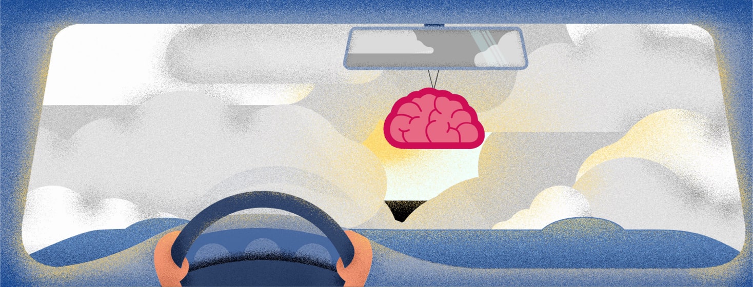 a person driving a car through a fog with a brain shaped air freshener